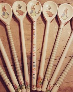 six wooden spoons with peter rabbit designs on them