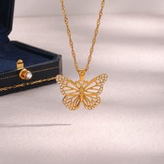 Description:Filled Hollowed-out Butterfly Chain NecklaceSpecifications:Material: cubic zirconia, stainless steel, 24k goldColors: goldSize: 40 cm + 5 cm extWeight: 6.5 g/pcs "Flutter with style with our Filled Hollowed-out Butterfly Chain Necklace. This unique necklace features a hollowed-out butterfly design that's filled with charm and elegance. A perfect accessory to complete your playful and quirky look. Get ready to spread your wings!" Butterfly Chain Necklace, Symbol Of Happiness, Butterfly Chain, Flying Flowers, Butterfly Necklace Gold, Butterfly Necklace, Butterfly Pendant, Butterfly Design, Dainty Jewelry