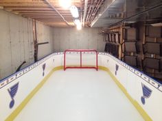 an indoor ice rink with yellow and white lines