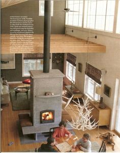 two people sitting at a table in front of an open fire place