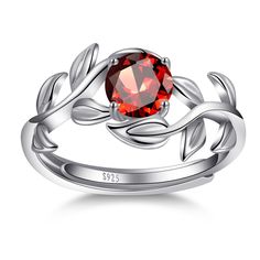 a silver ring with a red stone in the center and leaves on it's sides