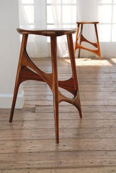 two wooden stools sitting on top of a hard wood floor