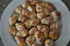 a white plate topped with donuts covered in icing