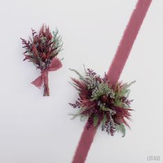 two bouquets of flowers tied together on a white surface