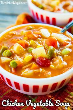 two bowls filled with chicken vegetable soup on top of a red and white table cloth