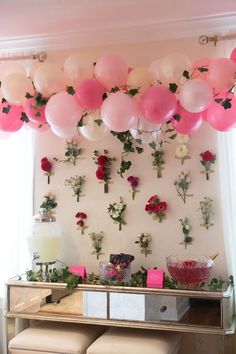 balloons and flowers are hanging from the ceiling