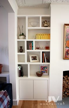 a living room filled with furniture and a fire place in front of a painting on the wall