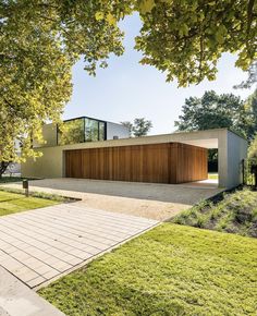 the modern house is surrounded by trees and grass