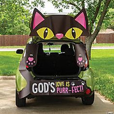 a car that has been decorated to look like a cat with the words god's love is purr - fect