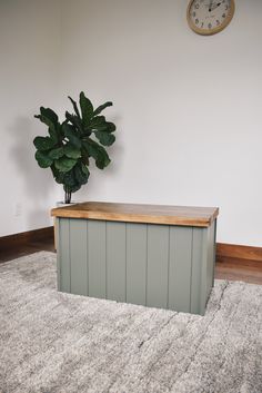 a potted plant sitting on top of a wooden bench next to a wall clock