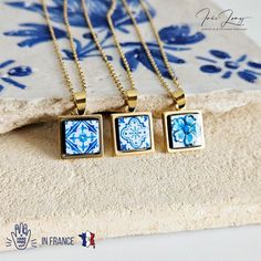 three necklaces with blue and white designs on them