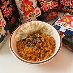 a bowl filled with noodles next to some snacks