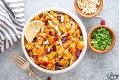 a white bowl filled with food next to two wooden bowls