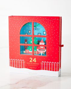 a red book with a christmas scene in the window