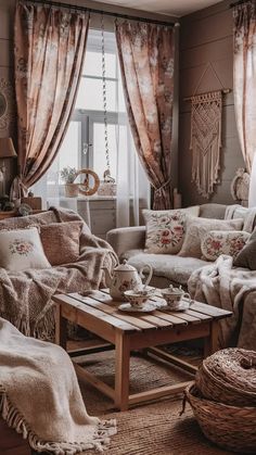 a living room filled with lots of furniture and pillows on top of a wooden table