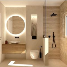 a bathroom with a sink, toilet and shower in it's center wall is illuminated by round mirrors