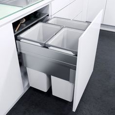 an open cabinet with two bins in the middle and one drawer on the other side