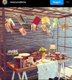 an image of a table with food on it and some books hanging from the ceiling