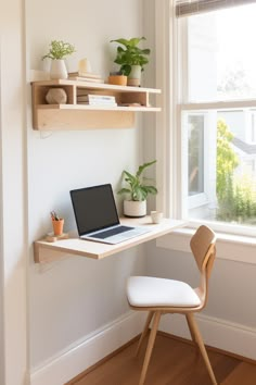 a laptop computer sitting on top of a wooden desk in front of a window next to a white chair