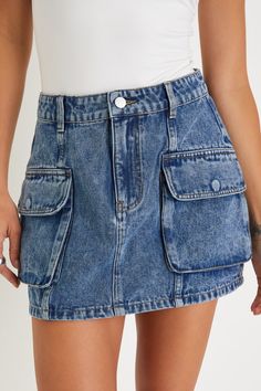 Dress it up with heels or keep it casual with platform sneakers, either way you'll be set to strut in the LUSH Dream City Medium Wash Denim Cargo Mini Skirt! Stay on trend in this medium wash, sturdy denim skirt that has a high-rise fit complete with belt loops, hidden zip fly, and top button closure. Figure-fitting silhouette features cargo-inspired snap pockets at the front before ending at a cute micro-mini hem. Fit: This garment fits true to size. Length: Above mid-thigh. Size medium measure Trendy High Rise Denim Cargo Skirt, Casual Denim Mini Skirt With Side Pockets, Trendy High Waist Denim Skirt With Side Pockets, Trendy High-waisted Denim Skirt With Side Pockets, Trendy Medium Wash Mini Cargo Skirt, Trendy Medium Wash Cargo Skirt For Summer, Fitted Casual Medium Wash Cargo Skirt, High Waist Denim Blue Cargo Skirt, Casual High Waist Denim Blue Cargo Skirt