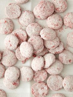 a pile of powdered donuts sitting on top of a table