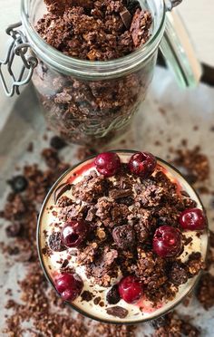 two jars filled with desserts sitting on top of a table