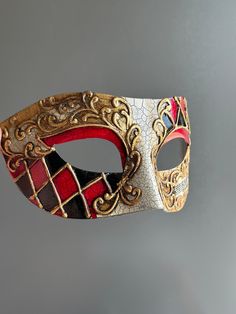 This Venetian style mask in red, black, and gold is perfect for any formal occasion or masquerade event! Thank you for supporting small businesses and hope our products bring you and loved ones some joy and humor in these trying times.    I N C L U D E D Masks come with matching double sided satin ribbons attached. S I Z E  Adult size. Detailed dimensions available upon request. C U S T O M I Z A T I O N If you would like to color & embellish the mask to match your costume/dress, choose custom color and get in touch, we love to work on custom orders!  C O N T A C T  Please contact us via ETSY messages. P H O T O  Images displayed on this listing are property of www.higginscreek.com A B O U T HigginsCreek makes elegant face Masks for masquerade balls, Prom Dances, Bachelorette parties, Grad Masquerade Mask Venetian, Masquerade Mask Vintage, Red Dragon Mask, Masculine Masquerade Mask, Clown Masquerade Mask, Mascarade Mask Drawing, Jester Masquerade Mask, Victorian Masked Ball, Fancy Masquerade Mask