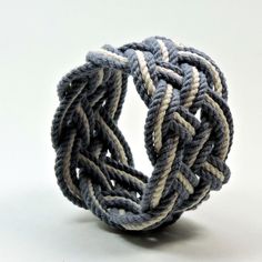 a ring made out of rope on a white surface