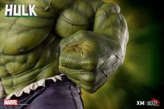 the incredible hulk statue is displayed in front of a black background