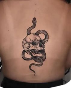 a man with a skull and snake tattoo on his back