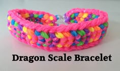 a pink bracelet with multicolored beads on the end and a white background that says dragon scale bracelet