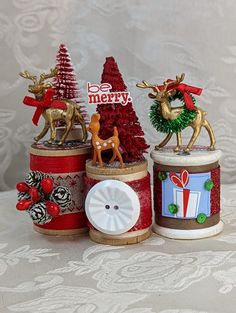 three christmas decorations sitting on top of a table