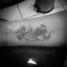 a person with a tattoo on their arm that says,'june'in cursive writing