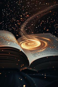 an open book with gold dust flying around it