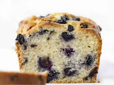 a loaf of blueberry bread sitting on top of a white counter