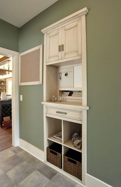 a kitchen with green walls and white cabinets