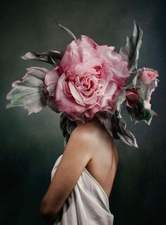 a woman in white dress with pink flowers on her head