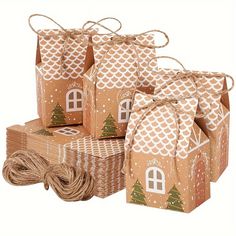 brown paper bags with trees on them and twine wrapped around the top one bag