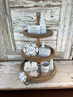 a three tiered tray with snowflakes on it