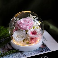 there is a glass ball with flowers in it