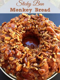 sticky bundt monkey bread on a white plate with caramel sauce and pecans