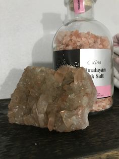 a bottle of himalayan salt next to a rock