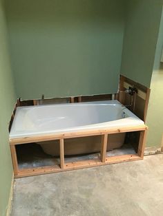 a bath tub sitting inside of a bathroom under construction