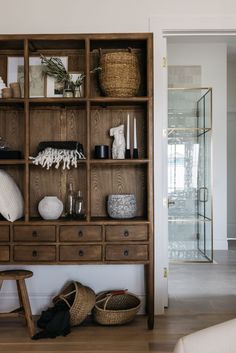 a wooden shelf with baskets and other items on it