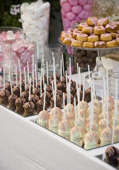 a table topped with lots of different types of desserts and candies next to each other