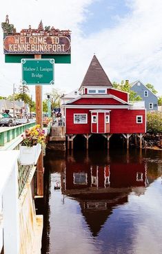 a red building sitting on the side of a river