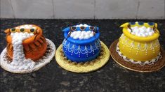 three cakes decorated like animals sitting on top of plates