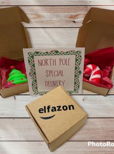 two boxes with christmas decorations in them on a wooden table next to a sign that says north pole special delivery