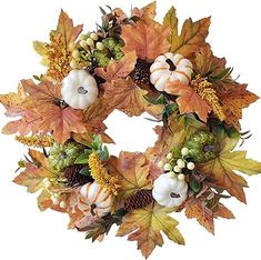 a wreath with pumpkins and leaves on it