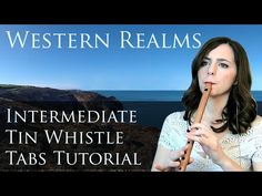 a woman holding a wooden stick in her hand with the words western realms on it